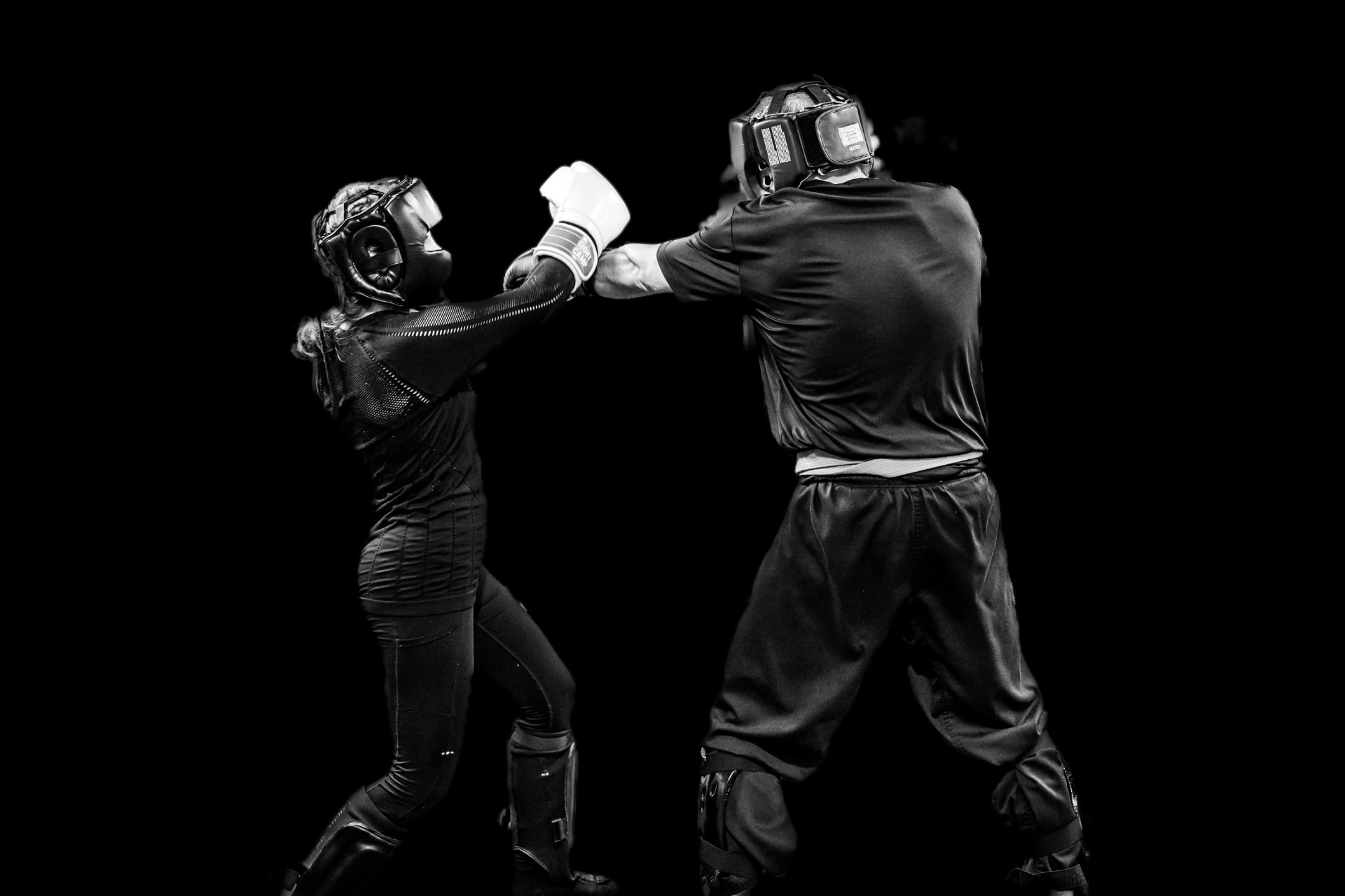 Self-defense coach and student training in protective gear