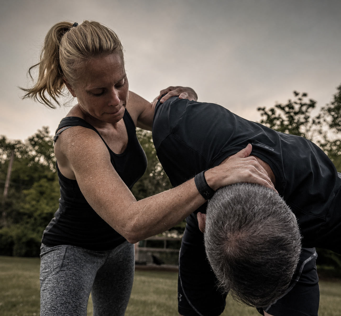 Person practicing a foundational self-defense stance in a bright studio
